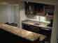 Custom built-in wet bar with Cherrywood cabinets and granite bar tops