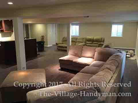 Large finished basement with new flooring, new walls and ceiling, new lighting, and built-in bar