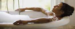 Woman relaxing in new bathroom tub